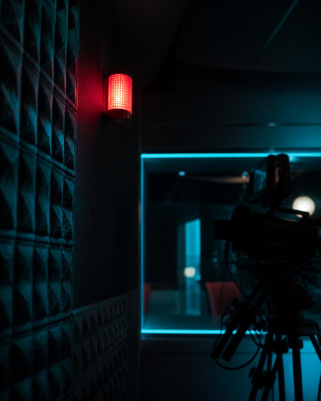 Broadcast studio at night, tally light on